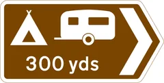 Camping and caravan site 300 yards in the direction indicated — UK road sign