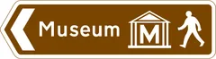 Direction of route to a tourist attraction for pedestrians — UK road sign