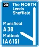 Motorway junction, displaying route number and destination reached as well as destination reached by remaining on the motorway — UK road sign