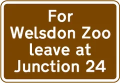 Exit from a motorway at a junction ahead that should be used for a tourist attraction — UK road sign