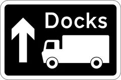 Motorway junction ahead leading to a route advised for goods vehicles to the destination shown, which may differ from that for other traffic — UK road sign