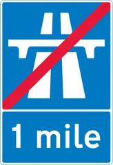 End of motorway regulations, including the national speed limit in 1 mile — UK road sign