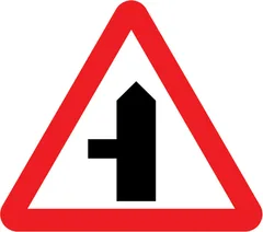 Side road ahead (left) — UK road sign