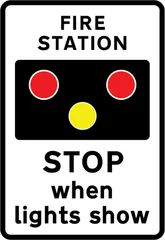 Warning of light signals in the vicinity of a fire station — UK road sign
