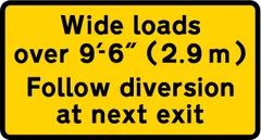 Instructions to drivers of wide loads to follow a diversion to avoid the road works ahead — UK road sign